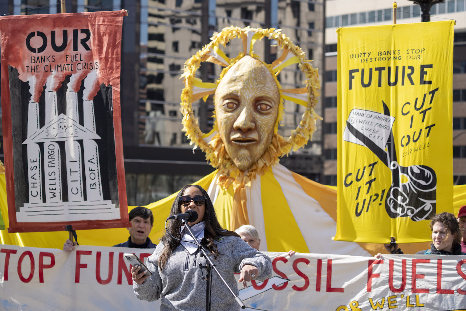 A woman speaks at a rally against fossil fuels